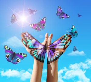 Hand and butterfly hand painting, tattoo, over a blue sky, concept for spiritual symbol of soul