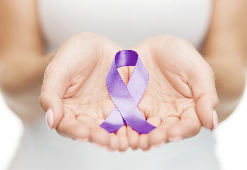 Hands holding a lavender ribbon